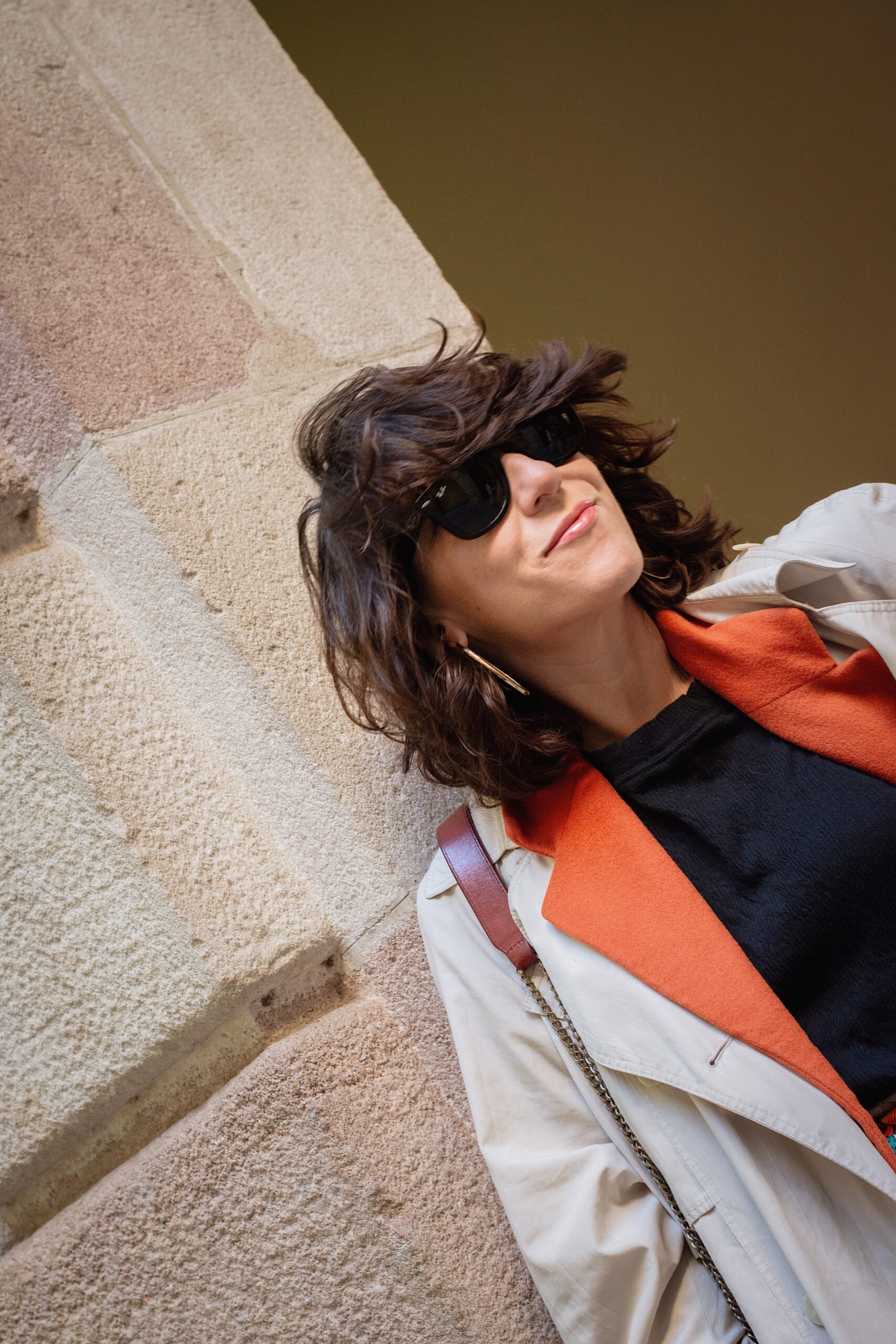 Look con gabardina y blazer de lana naranja vintage, pantalones negros arrugados, pañuelo de seda en la cintura y bailarinas Repetto Paris