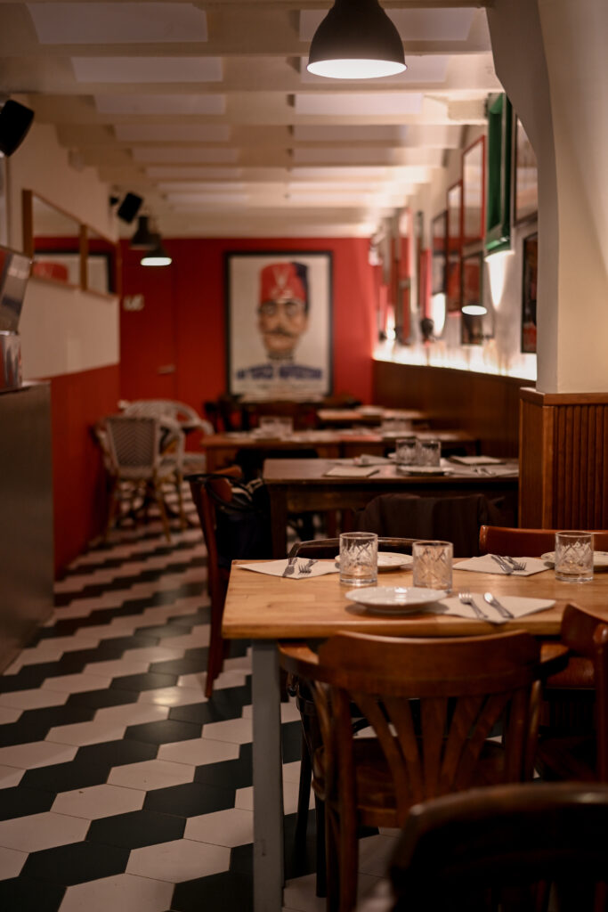 Comedor interior de Trattoria Enriquetto con cocina vista, decoración cálida y ambiente acogedor